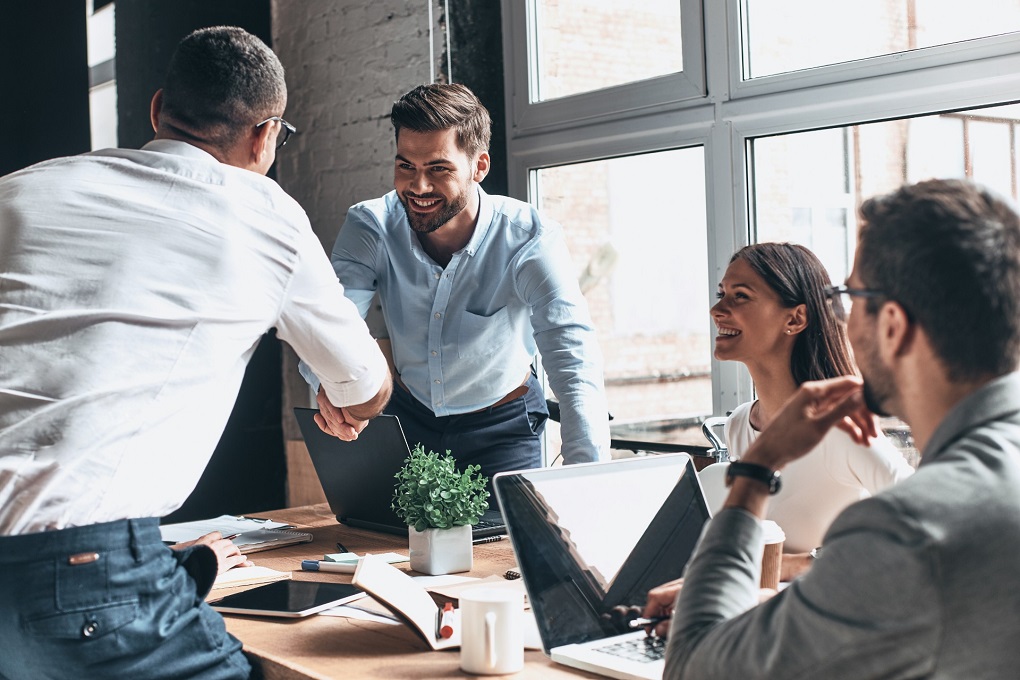 Photo of individuals working together for an article about managing a condo association